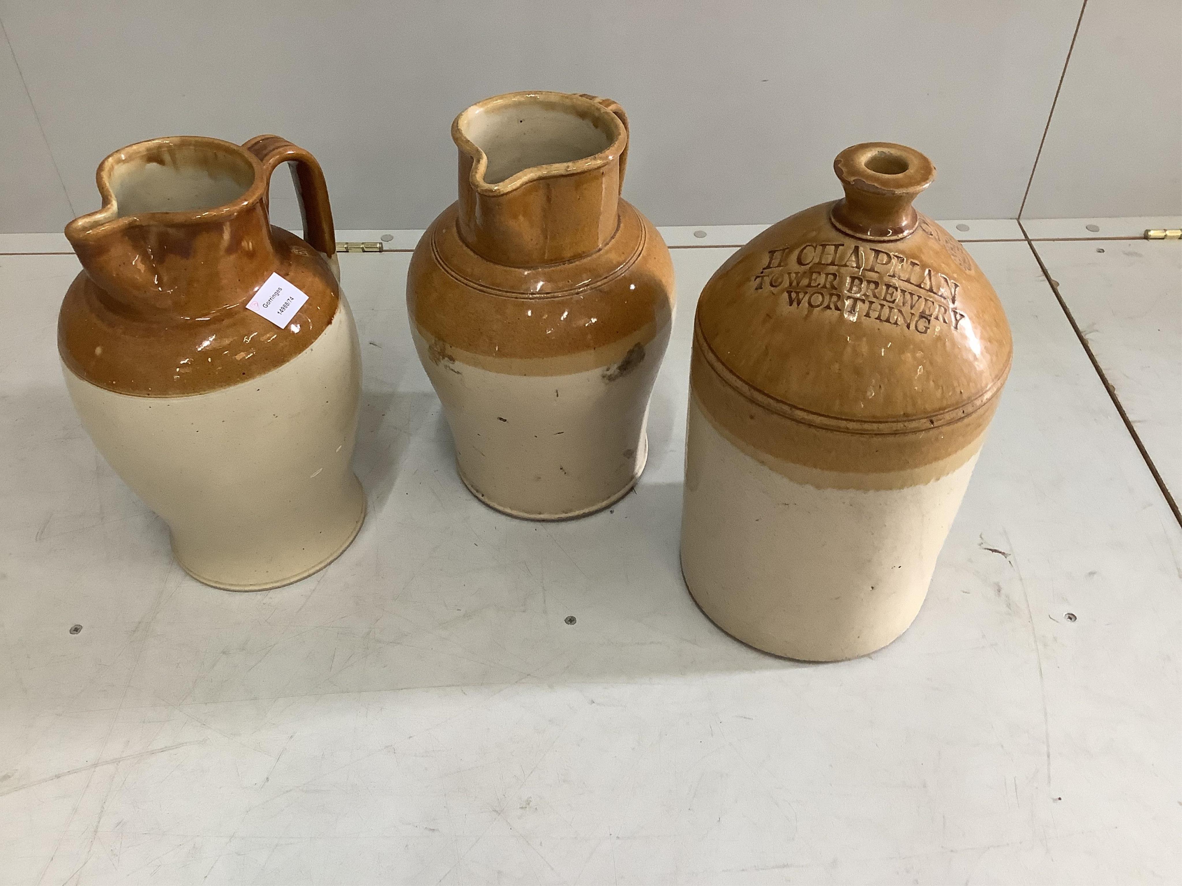 A Victorian Doulton Lambeth glazed earthenware ewer, a similar ewer and a Worthing beer flagon, largest height 41cm. Condition - good